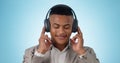 Music, business man and calm with headphones and studio with radio and audio app with blue background. Tech, smile and