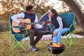 Music, camping and couple with guitar in nature for romantic vacation, adventure or holiday. Love, singing and young man Royalty Free Stock Photo