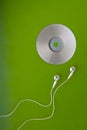 Music CD headphones or earphones on green Royalty Free Stock Photo