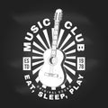 Music club logo, badge, label on chalkboard. Retro poster, banner with classical acoustic guitar with sunburst vintage Royalty Free Stock Photo