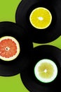 Music Colors concept. Collection of vintage vinyl records with lemon and grapefruite slice. Vintage Retro music record concept