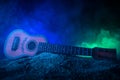 Music concept. Acoustic guitar isolated on a dark background under beam of light with smoke with copy space. Guitar Strings, close Royalty Free Stock Photo