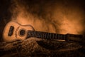 Music concept. Acoustic guitar isolated on a dark background under beam of light with smoke with copy space. Guitar Strings, close Royalty Free Stock Photo