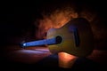 Music concept. Acoustic guitar isolated on a dark background under beam of light with smoke with copy space. Guitar Strings, close Royalty Free Stock Photo