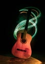 Music concept. Acoustic guitar isolated on a dark background under beam of light with smoke with copy space. Guitar Strings, close Royalty Free Stock Photo