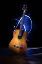 Music concept. Acoustic guitar isolated on a dark background under beam of light with smoke with copy space. Guitar Strings, close Royalty Free Stock Photo