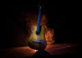 Music concept. Acoustic guitar isolated on a dark background under beam of light with smoke with copy space. Guitar Strings, close Royalty Free Stock Photo