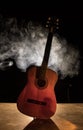 Music concept. Acoustic guitar isolated on a dark background under beam of light with smoke with copy space. Guitar Strings, close Royalty Free Stock Photo