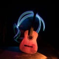 Music concept. Acoustic guitar isolated on a dark background under beam of light with smoke with copy space. Guitar Strings, close Royalty Free Stock Photo