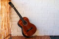 Music Concept: Brown acoustic guitar on a white wall