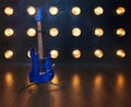 Music concept. Electric guitar standing on the wooden floor near Royalty Free Stock Photo