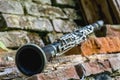 Music concept. Old clarinet on a background of a beautiful old broken brick wall Royalty Free Stock Photo