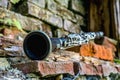 Music concept. Old clarinet on a background of a beautiful old broken brick wall Royalty Free Stock Photo