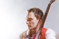 Music Concepts. Portrait of Young Male Guitar Player Against Gra Royalty Free Stock Photo