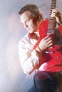 Music Concepts. Portrait of Young Male Guitar Player Performing Royalty Free Stock Photo