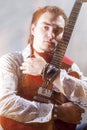Music Concepts. Portrait of Young Male Guitar Player Posing with Royalty Free Stock Photo