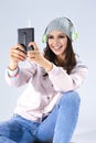 Music Concepts. Positive Happy Caucasian Brunette Girl in Pink Hoodie