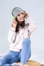 Music Concepts. Positive Happy Caucasian Brunette Girl in Pink Hoodie