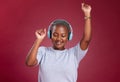 Music, dance and freedom with a black woman in studio on a red background for dancing or fun. Dancer, headphones and Royalty Free Stock Photo