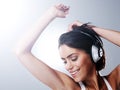 Music, dance and happy woman with headphones in studio with freedom, party and celebration. Dancer, performance and Royalty Free Stock Photo