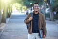 Music, education and portrait of a black man at a park for a walk, learning and studying in nature. Happy, university Royalty Free Stock Photo