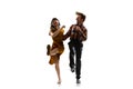 Dynamic portrait of stylish dancers, young man and woman in vintage attire dancing swing isolated on white background