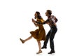 Dynamic portrait of stylish dancers, young man and woman in vintage attire dancing swing isolated on white background