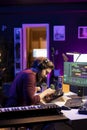 Music engineer using mixing console to add sound effects on tracks