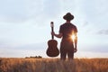 Music festival background, silhouette of musician artist with acoustic guitar