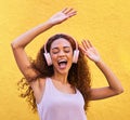 Music, freedom and dance with a black woman listening to the radio outdoor on a yellow wall background. Headphones Royalty Free Stock Photo