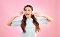 Music headphones, singing and woman dancing in studio isolated on a pink background. Singer, radio dance and happy mixed