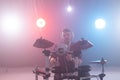 Music, hobby and people concept - young man drummer playing the electronic drums on the stage Royalty Free Stock Photo