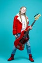 Music Ideas and Concepts. Smiling Caucasian Guitar Player Posing and Playing Electro Guitar Sitting In Fashionable Red Jacket Over
