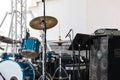 Music installation with drums standing outdoors before concert