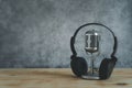 Music instruments concept background. Close up group of musical tools the vintage michophone, headphone on brown wooden and grey Royalty Free Stock Photo