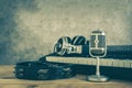 Music instruments concept background. Close up group of musical tools the vintage michophone, headphone,tambourine on brown wooden Royalty Free Stock Photo