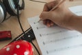 Music instruments concept background. Close up musician writing note on the paper for create song with the group of musical tools