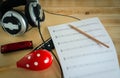 Music instruments concept background. Close up musician writing note on the paper for create song with the group of musical tools