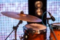 MUSIC INSTRUMENTS DRUMS AND MICROPHONE ON STAGE, IN BACKGROUND LIGHT BARS. Royalty Free Stock Photo