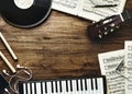 Music instruments and earphones on wooden table Royalty Free Stock Photo