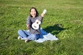 Music and instruments. Portrait of cute asian girl shows her white ukulele, plays in park while sitting relaxed on Royalty Free Stock Photo