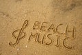 Music key and text beach music drawn on a sand.