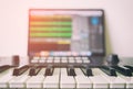 Music keyboard with Computer running DAW music production. Royalty Free Stock Photo