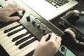 Music keyboard player is adjusting sound synthesizer Royalty Free Stock Photo