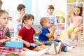 Music lesson for group of children in kindergarten Royalty Free Stock Photo