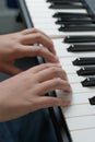 Music lessons. Two hands piano playing exercises. Keyboard close-up