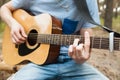 Music lifestyle man playing guitar nature concept.