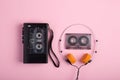 Music listening concept. Vintage cassette tape, audio player and headphones close-up on pink background, top view Royalty Free Stock Photo