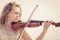 Woman playing violin on violin near beach Royalty Free Stock Photo