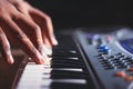 Music magician Playing the Electronic Keyboard in Music Recording studio close up on hands. Playing electronic Piano